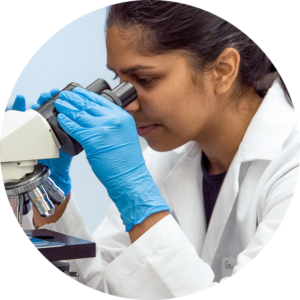 Female scientist looking into a microscope